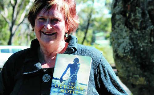 Judy Currie with her son Christopher’s debut novel The Ottoman Motel.